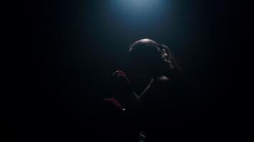 Strong woman fighter practicing fast and strong hand strikes, shadow boxing in an abandoned room in slow motion 4k footage video