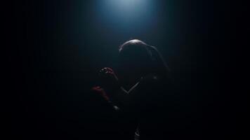 A female fighter demonstrates her hand-to-hand combat skills by practicing strikes on an imaginary opponent. video