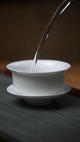 Master the Elegant Art of Tea Pouring with Traditional Chinese Teaware for a Unique Experience. Media video