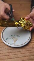 Engaging in the creative crafting process using gold foil alongside a pair of scissors. Media video