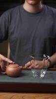 An Artisan Tea Setup with a Teapot and Glass Cup, enhancing the serene experience of brewing. Media video