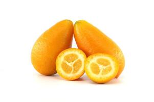 Two kumquats and two halves showing the pulp on a white background photo