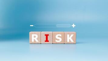 RISK management and set text at wooden blocks on light blue background, Business control and strategy, Increasing and decreasing business risk, Business decision making and marketing analysis. photo