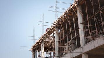 Construction site, Metal scaffolding and formwork, Beam formwork support system of newly built building at construction site on blue sky background with copy space, Residential buildings Construction photo