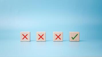 Checkbox with green check mark from row of multiple boxes with red crosses on blue background, Pro and contra or accept and decline, Strategy of choice, Concept of positive or negative decision. photo