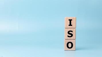 ISO, Standard certification standardisation quality control concept, Wooden blocks with the letters ISO for quality management of organizations on a light blue background, Certified and quality. photo