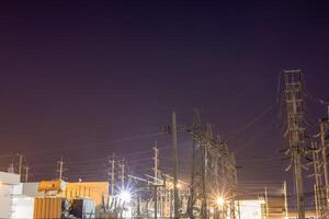 High voltage power transmission point, High voltage electric insulated yard, Is an access point for multiple power supply points, evening duration. photo