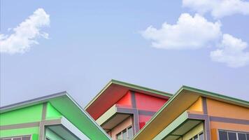 Simple colorful Concrete House with Roof in Village for Sale, Basic Home for Medium Small Family Residential, Blue Sky and Cloud in Background with Copy Space. photo