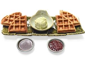 Homemade ice cream with waffle on a plate with chocolate syrup and marmalade photo