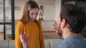 Stressed annoyed Caucasian dad male father man shout at upset daughter in fault kid at home conflict guy discipline little child family difficulty parent arguing schoolgirl girl bad behavior trouble video