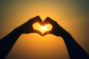 Romantic Heart Shaped Hands Silhouette with Glowing Sunset Light Symbolizing Love and Connection in Warm Golden Hues photo