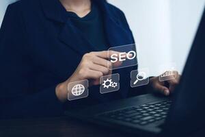Businesswoman uses notebook computer to optimize SEO and online marketing search concept. photo