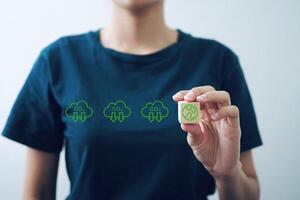 Businesswoman holding a wooden block with a picture of the world And the clouds represent decarbonization to reduce carbon dioxide, climate change, green economy concepts. photo