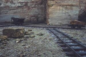Remnants of a bygone era found in an abandoned quarry with old tracks and mining equipment photo