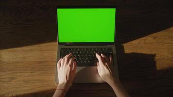 Top view of caucasian woman hands start typing code on laptop computer with green screen chroma key video