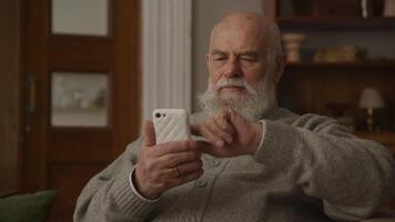 Elderly Man Laughing while Browsing on Smartphone video