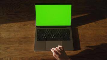 Top view caucasian woman hand double click on laptop computer touchpad with green screen video