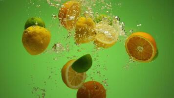 Mix of exotic citrus fruits falling into water in slow motion - orange, lime, grapefruit, lemon video