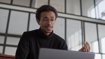 Man speaking on call using laptop video