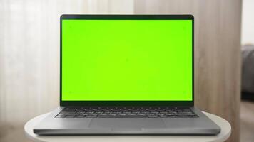 Laptop with Green Screen on Table Reveal in Minimalistic Setting video