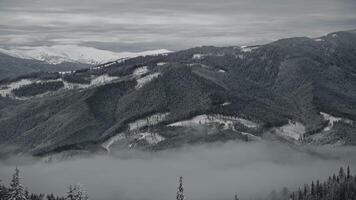 Slow optical zoom out from a winter mountain range scenery with snow covering all over video