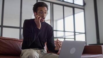 Man having phone call while working on laptop video