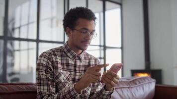 Man Using Smartphone While Sitting on Couch video