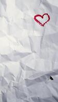 Valentines day Wrinkled paper texture vertical background White crumpled sheet with hearts stop motion seamless loop video