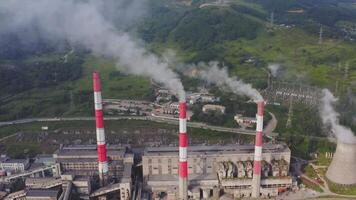 Aerial view of the pipes of a coal power plant and cooling tower video