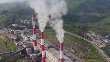 Aerial view of the pipes of a coal power plant and cooling tower video