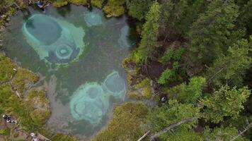 Aerial view of the geyser lake of turquoise color with crystal clear water video