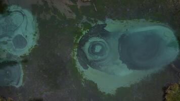 Aerial view of the geyser lake of turquoise color with crystal clear water video