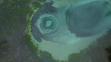 Aerial view of the geyser lake of turquoise color with crystal clear water video