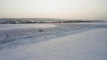 View from a drone to the ground covered with snow at the morning video