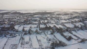 View from a drone to the ground covered with snow at the morning video