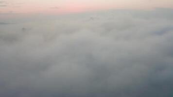 Drone view of the city, bay and big bridge covered with fog at sunset video