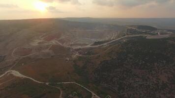 Aerial view of opencast mining quarry with lots of machinery at work video