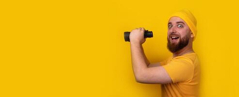smiling bearded man with binoculars photo