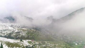 Cloud and mist, top of view to green field and snow, foggy landscape mountain, valley village clouds, green fields picturesque, rural serene, breathtaking tranquil, natural misty video