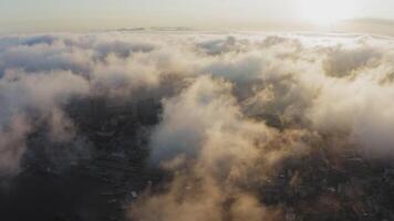 View from a drone of city center, above which clouds are rapidly floating video