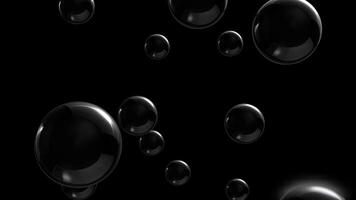 4K seamless loop of 3D animation of shiny black spheres slowly moving on a black background. video