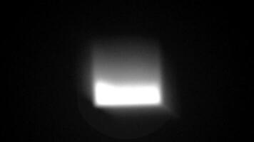 4K seamless loop of Rotating gradient gray light on black background. video