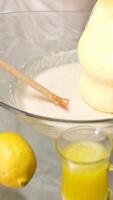 Bakery. Closeup view of a woman beating a key lime pie cream in a glass bowl with an electric mixer. video