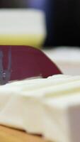 Chef in black gloves cuts butter to add to salad video