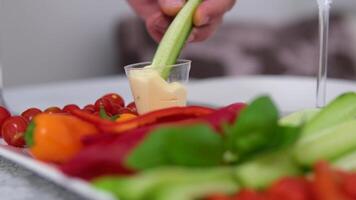 cucumber with mayonnaise. diet vegetarianism dip freshly cut cucumber in sauce a piece of cucumber to dip into the sauce video
