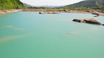 Drone view of the turquoise lake formed as a result of mining waste video
