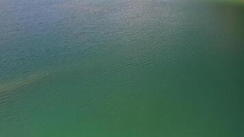 Drone view of the turquoise lake formed as a result of mining waste video