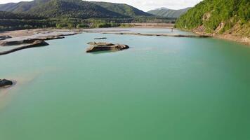 Drone view of the turquoise lake formed as a result of mining waste video