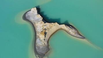 Drone view of the turquoise lake formed as a result of mining waste video