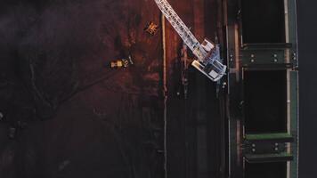 Port logistics from above. Drone view of coal handling and crane video